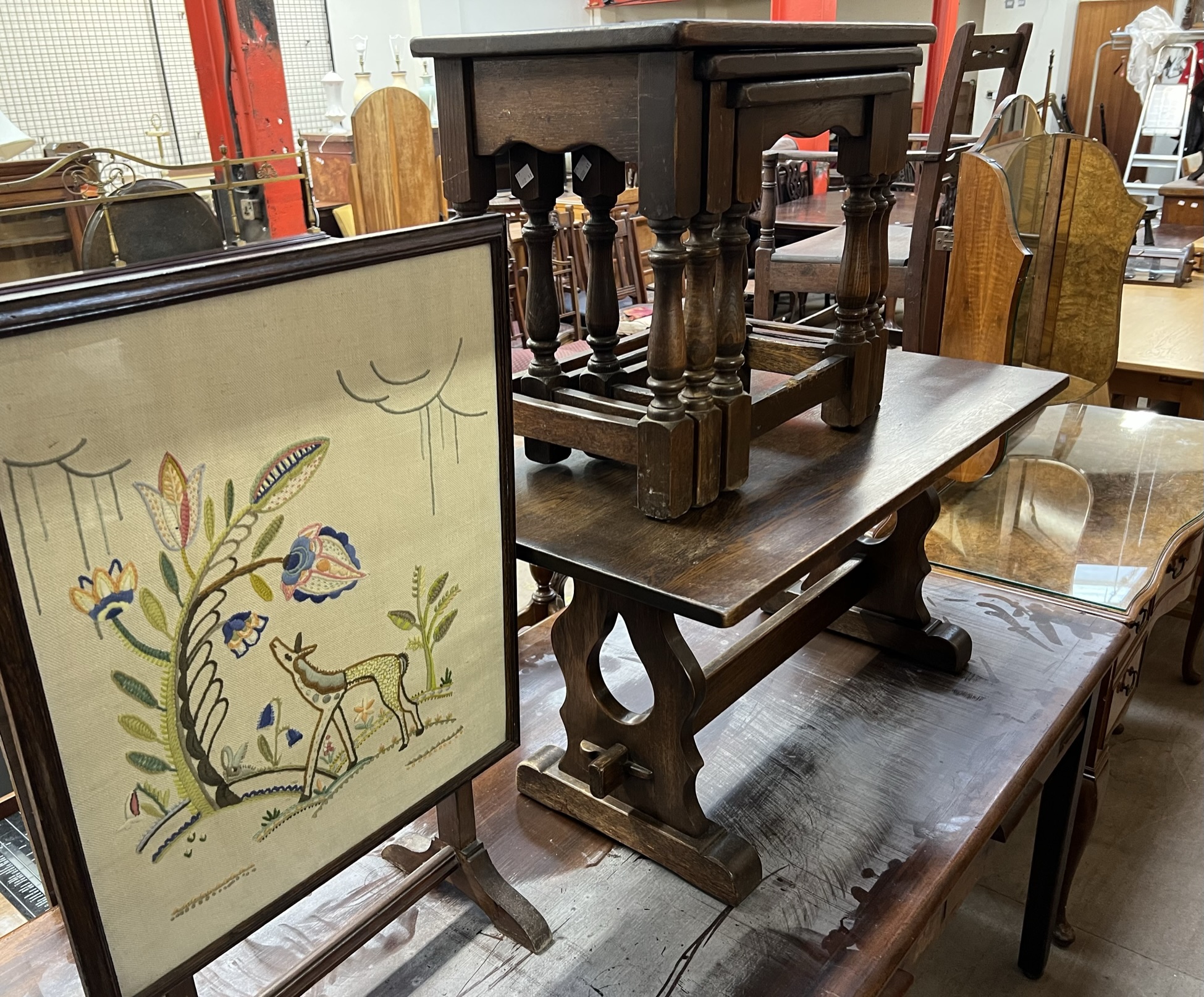 An oak nest of tables together with an oak occasional table and a fire screen