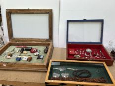 Three table top display cabinets including amber beads, bone handled Stanhope propelling pencil,