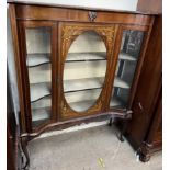 An Edwardian mahogany display cabinet, with a glazed door,