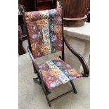 An Edwardian folding chair with floral upholstery