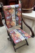 An Edwardian folding chair with floral upholstery