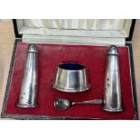 A cased silver cruet set together with white metal topped dressing table pots,