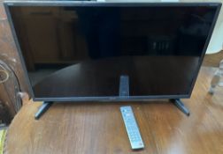A Sharp Aquos 32" LED LCD television and remote (Sold as seen,