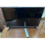 A Sharp Aquos 32" LED LCD television and remote (Sold as seen,