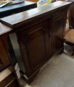 A 19th century oak side cabinet with a rectangular top above a pair of cupboard doors on bracket