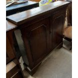 A 19th century oak side cabinet with a rectangular top above a pair of cupboard doors on bracket