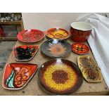 A collection of Poole pottery plates, bowl etc decorated in oranges,