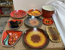 A collection of Poole pottery plates, bowl etc decorated in oranges,