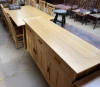 A modern light oak dining suite comprising an extending dining table, two additional leaves,
