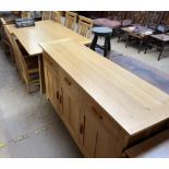 A modern light oak dining suite comprising an extending dining table, two additional leaves,