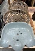 A "Victor" cast iron tractor seat together with two other cast iron tractor seats