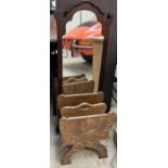 A continental oak magazine rack carved with figure heads together with a mahogany framed wall