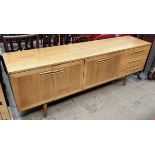 A mid 20th century teak sideboard with a rectangular top above three drawers,