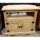 A 20th century pine corner television cabinet with a pair of cupboard doors