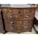 A George III mahogany chest of drawers with a bowed top above two short and three long drawers on
