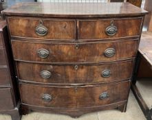 A George III mahogany chest of drawers with a bowed top above two short and three long drawers on