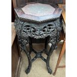 A Chinese hardwood jardiniere stand of octagonal form with a marble inset top above a flower and