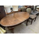 A 20th century mahogany extending dining table on cabriole legs and pad feet together with a pair