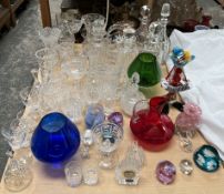 A collection of crystal decanters together with crystal drinking glasses, Murano glass clown,