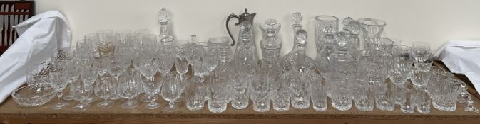 A large quantity of crystal drinking glasses, decanters,