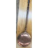 A copper bedwarming pan,