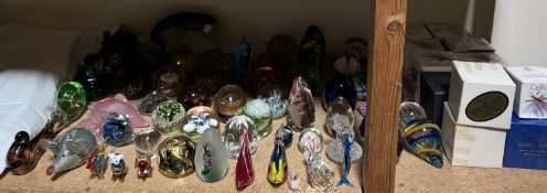 A collection of Caithness and other glass paperweights together with glass animals,