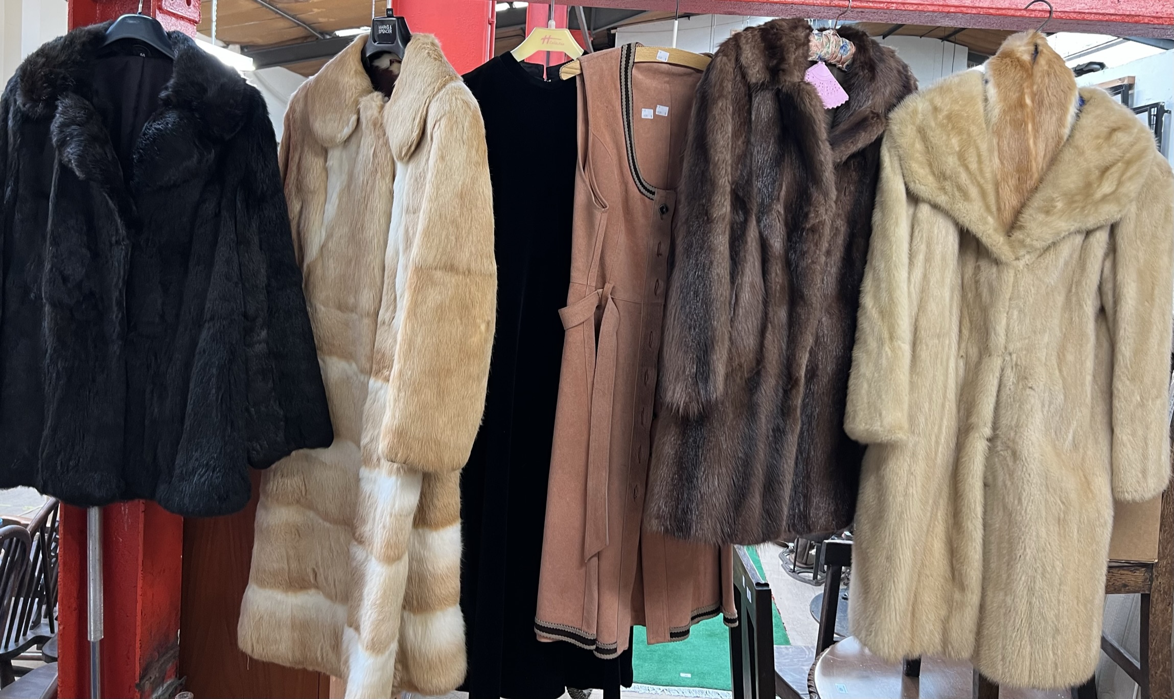 Four fur coats together with a jacket and a dress