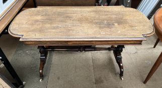 A Victorian rosewood centre table with a shaped oval top on tapering columns and splayed legs and