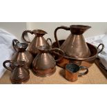 A set of five copper measuring jugs,