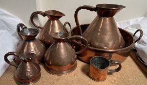 A set of five copper measuring jugs,