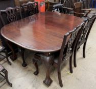 A 19th century mahogany extending dining table with an oval top on leaf carved cabriole legs and