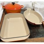 A Le Crueset casserole dish and cover together with two Le Crueset open dishes