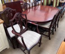 A reproduction mahogany extending dining table and six chairs