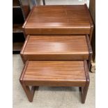 A mid 20th century nest of three teak tables