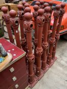 A set of sixteen cast iron fence posts with ball finials on square bases,
