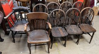 A smokers bow elbow chair together with seven wheel back dining chairs and another oak elbow chair