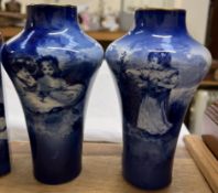 A pair of Royal Doulton blue and white vases transfer decorated with children seated under a tree,