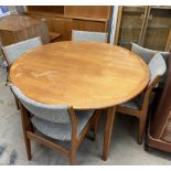 A mid 20th century teak dining suite comprising an extending dining table and five chairs,