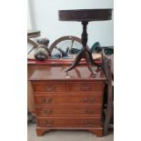 A modern yew chest of drawers together with a leather topped occasional table