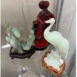 A Royal Doulton flambe figure lamp seller HN3278 together with two jade like hardstone figures of