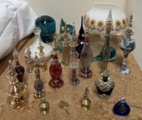 A Mdina scent bottle together with Mdina paperweights and a collection of glass scent bottles and