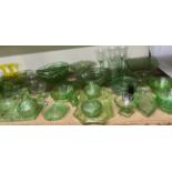 A large collection of Uranium glass including part dressing table sets, drinking glasses, bowls,