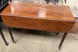 A Victorian mahogany Pembroke table with drop flaps on reeded legs