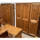 A pine triple wardrobe together with a pine double wardrobe, pine dressing table,