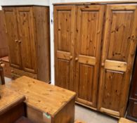 A pine triple wardrobe together with a pine double wardrobe, pine dressing table,