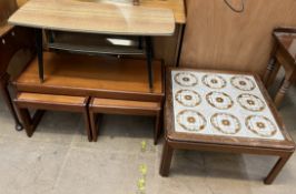 A mid 20th century teak coffee table and nest of two tables together with a tiled top coffee table