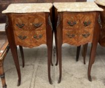 A pair of marquetry inlaid bedside chests with marble tops and two drawers on shaped legs and sabot