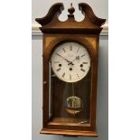 A Comitti of London mahogany cased wall clock with a broken swan neck pediment and circular dial