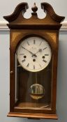 A Comitti of London mahogany cased wall clock with a broken swan neck pediment and circular dial