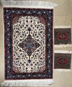 A Chinese 200 line wool pile cream ground rug with floral centre,